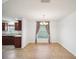Dining room with tile floors, wood cabinets, and curtains framing a bright window at 4321 High Ridge Ave, Spring Hill, FL 34609