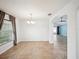 Bright dining area with tile flooring, chandelier, and an archway leading to the living space at 4321 High Ridge Ave, Spring Hill, FL 34609
