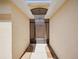 Covered entrance featuring a tile-accented walkway, archway and a storm door with a view to the main door at 4321 High Ridge Ave, Spring Hill, FL 34609