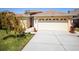 Exterior of this home with two car garage and landscaping, featuring a beautiful decorative tree at 4321 High Ridge Ave, Spring Hill, FL 34609