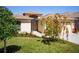 This home has a charming front yard with beautiful green grass and landscaped bushes, plants, and a tree at 4321 High Ridge Ave, Spring Hill, FL 34609
