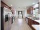Well-lit kitchen featuring tile flooring, ample cabinets and stainless steel appliances at 4321 High Ridge Ave, Spring Hill, FL 34609