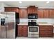 Modern kitchen features sleek, stainless steel appliances and ample cabinet storage at 4321 High Ridge Ave, Spring Hill, FL 34609