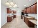Expansive kitchen with dark wood cabinetry, tile floors, and modern appliances at 4321 High Ridge Ave, Spring Hill, FL 34609