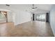 Open-concept living room with tile floors, ceiling fan, and sliding glass doors to outdoor space at 4321 High Ridge Ave, Spring Hill, FL 34609
