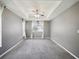 Main bedroom featuring tray ceiling, ceiling fan, neutral walls, carpet, and window at 4321 High Ridge Ave, Spring Hill, FL 34609