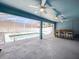 Enclosed pool and outdoor bar area with ceiling fans and ample space for entertaining and enjoying the pool view at 4321 High Ridge Ave, Spring Hill, FL 34609