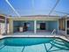 Inviting outdoor living with covered patio, bar and screened-in pool at 4321 High Ridge Ave, Spring Hill, FL 34609