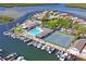 Stunning aerial view showcasing a waterfront community with boat docks, pool, and tennis courts at 4504 Dewey Dr, New Port Richey, FL 34652