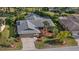 Aerial view of a home with gray roof, landscaping, and an attached two-car garage at 4504 Dewey Dr, New Port Richey, FL 34652