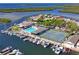 Aerial view of community pool, tennis courts, boat slips, and waterfront homes at 4504 Dewey Dr, New Port Richey, FL 34652