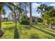 Lush backyard featuring mature trees and landscaping, providing a private and serene outdoor space at 4504 Dewey Dr, New Port Richey, FL 34652