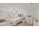 Bright bedroom featuring soft carpet, ceiling fan, and ample natural light from two windows at 4504 Dewey Dr, New Port Richey, FL 34652