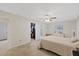 Bedroom with an open closet and attached bathroom, carpeted floors, and a ceiling fan at 4504 Dewey Dr, New Port Richey, FL 34652
