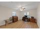 Bedroom with ceiling fan, two windows, and light wood flooring at 4504 Dewey Dr, New Port Richey, FL 34652