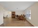 Open dining room with wood floors, built-in bar, and natural light from multiple windows at 4504 Dewey Dr, New Port Richey, FL 34652