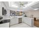 Bright kitchen featuring white cabinets, stainless steel appliances, and a ceiling fan at 4504 Dewey Dr, New Port Richey, FL 34652