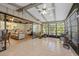 Enclosed lanai with tile floors and views of the landscaped backyard at 4504 Dewey Dr, New Port Richey, FL 34652