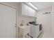 Well-equipped laundry room featuring a new washer and dryer, ample storage, and a utility sink at 4504 Dewey Dr, New Port Richey, FL 34652
