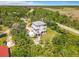 An aerial view of a coastal home with dual decks, lush surroundings, and a fire pit area at 4514 Fishman Ave, Weeki Wachee, FL 34607
