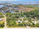 A beautiful aerial view of a coastal home surrounded by lush greenery, marshland, and serene waterways at 4514 Fishman Ave, Weeki Wachee, FL 34607
