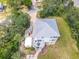 An aerial view of a home with a metal roof, spacious deck, and a boat parked in the driveway at 4514 Fishman Ave, Weeki Wachee, FL 34607