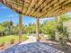 Lovely covered back patio leads to a bricked seating area with peaceful views of the backyard at 4514 Fishman Ave, Weeki Wachee, FL 34607