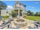 Home's backyard featuring a paved fire pit area surrounded by chairs, perfect for outdoor entertaining at 4514 Fishman Ave, Weeki Wachee, FL 34607