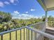 Enjoy lush green views from this home's comfortable balcony on a beautiful day at 4514 Fishman Ave, Weeki Wachee, FL 34607