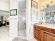 Bathroom featuring vanity with framed mirror, walk-in glass shower, and coastal-inspired decor at 4514 Fishman Ave, Weeki Wachee, FL 34607