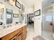Bathroom featuring vanity with framed mirror, walk-in glass shower, and coastal-inspired decor at 4514 Fishman Ave, Weeki Wachee, FL 34607