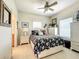 Inviting bedroom featuring a floral comforter, neutral walls, ceiling fan, and a window for natural light at 4514 Fishman Ave, Weeki Wachee, FL 34607