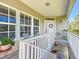 Charming front porch with seating and a view of the entrance, creating a welcoming feel at 4514 Fishman Ave, Weeki Wachee, FL 34607