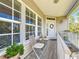 Inviting front porch features neutral siding, white railings, and a cozy seating area at 4514 Fishman Ave, Weeki Wachee, FL 34607