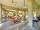 The airy ground floor features an outdoor dining area, a porch swing, and ample space for activities at 4514 Fishman Ave, Weeki Wachee, FL 34607