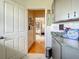 Hallway view showing a tiled floor leading to a bedroom with hardwood flooring and cabinets at 4514 Fishman Ave, Weeki Wachee, FL 34607