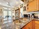 Granite countertops surround the stainless steel sink in this bright, open kitchen at 4514 Fishman Ave, Weeki Wachee, FL 34607