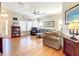 Bright living room featuring hardwood floors, plenty of seating, and natural light from large windows at 4514 Fishman Ave, Weeki Wachee, FL 34607