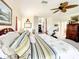 Spacious main bedroom with four-poster bed, ceiling fan,Peloton exercise bike, and large windows at 4514 Fishman Ave, Weeki Wachee, FL 34607