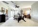 Large main bedroom with four-poster bed, ceiling fan, Peloton bike, and a view to the outside at 4514 Fishman Ave, Weeki Wachee, FL 34607