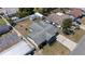 A captivating aerial view of a well-maintained home showcasing its roof, backyard with privacy fence, and long driveway at 4607 Kennedy Dr, New Port Richey, FL 34652