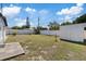 Spacious backyard featuring a privacy fence, a storage shed, and a small concrete patio, ideal for outdoor activities at 4607 Kennedy Dr, New Port Richey, FL 34652