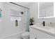 Bright bathroom with modern finishes, featuring an illuminated mirror and shower-tub combination at 4607 Kennedy Dr, New Port Richey, FL 34652
