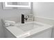 Close-up of a bathroom sink with a white countertop, black faucet, and decorative accents at 4607 Kennedy Dr, New Port Richey, FL 34652