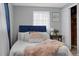 Comfortable bedroom featuring plush bedding, soft lighting, and a cozy atmosphere with neutral tones at 4607 Kennedy Dr, New Port Richey, FL 34652