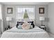 Bright bedroom featuring a plush bed with decorative pillows and natural light from a window at 4607 Kennedy Dr, New Port Richey, FL 34652
