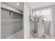 Closet with shelving, mirrored sliding door, and accent plant in a bright, airy setting at 4607 Kennedy Dr, New Port Richey, FL 34652