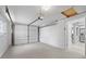 Spacious garage with white door and access to interior of home at 4607 Kennedy Dr, New Port Richey, FL 34652