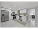 Clean kitchen with stainless steel appliances, bright cabinets, and tile flooring at 4607 Kennedy Dr, New Port Richey, FL 34652