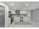 Bright eat-in kitchen features stainless steel appliances and white cabinetry at 4607 Kennedy Dr, New Port Richey, FL 34652